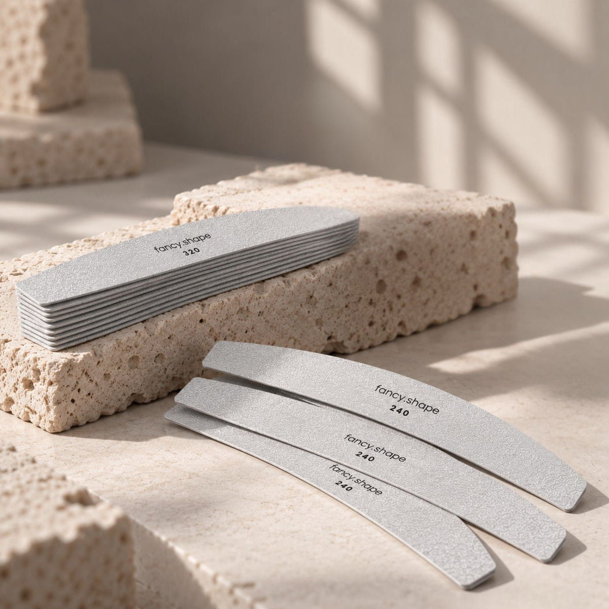 fancyhands® fancy.shape Wechselblätter in 240 und 320 Grit auf beigem Stein arrangiert